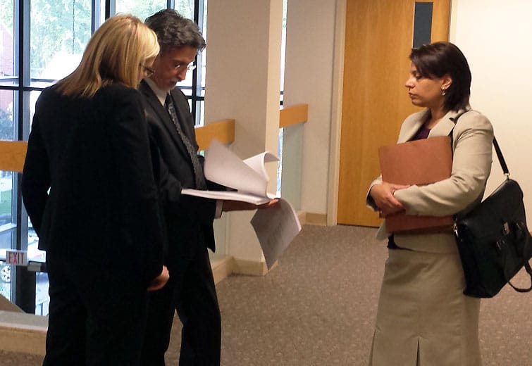 Attorney Joseph Olimpi reviews the legal filings against McKee outside of Judge McBride's courtroom / photo by John Paul